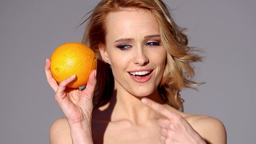 Smiling Woman Posing with an Orange, Beauty and Health
