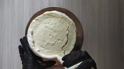 Decorating Round Cake with White Frosting Overhead