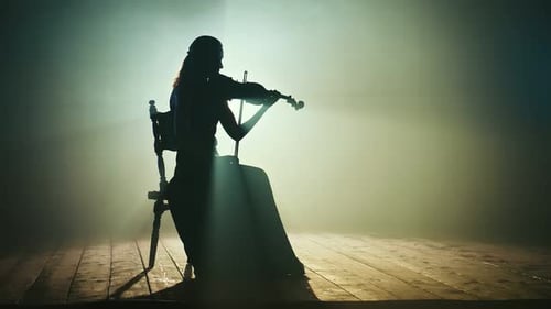 Woman Silhouette Playing Violin on Stage