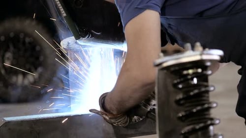 Welding Process. Worker Doing Welding Job. Hands Of Workman Doing Welding Parts