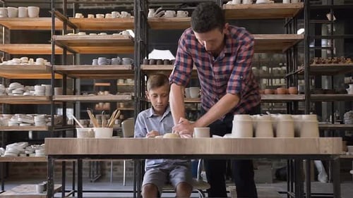 Adult and Boy Crafting Pottery Together