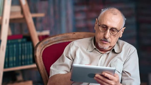 Senior Man Relaxing with Tablet in Cozy Home