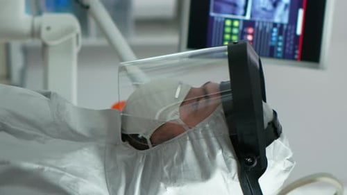 Man Wearing Protective Face Shield Lying on Bed