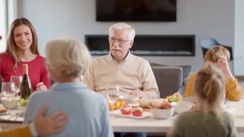 Family Gathering Around Dining Table to Celebrate