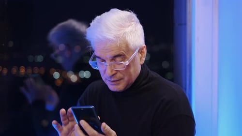 Senior Adult Using Smartphone at Night