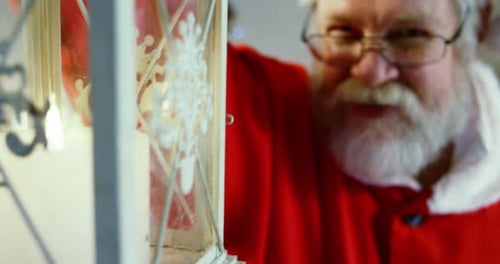 Portrait of santa claus holding lantern 4k