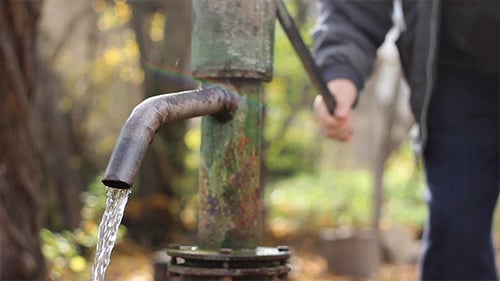 Antique Water Pump Dispensing Fresh Water Outdoors