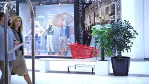 Adult Caucasian Couple Strolling in Shopping Center and Stop at Luxurious Shop. Portrait of