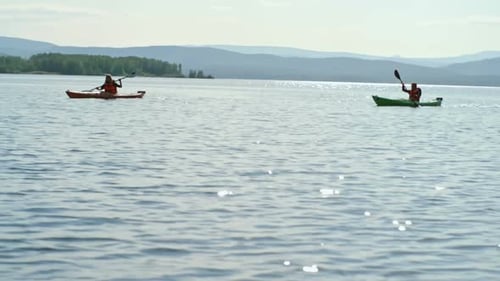People Kayaking on Lake in Sunny Weather