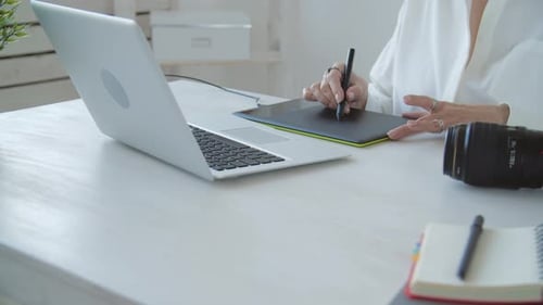 Woman Drawing on Graphics Tablet at Desk