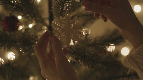 Woman Decorating On Christmas Tree