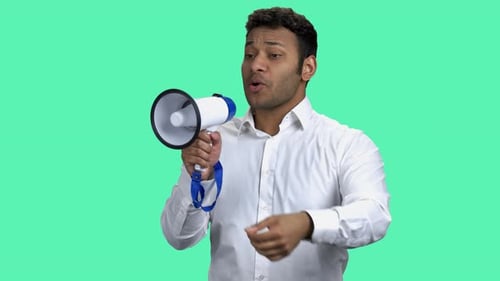 Young Adult Speaking Into Megaphone On Green Screen