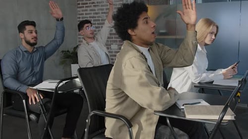 Students Raising Hands in Modern Classroom