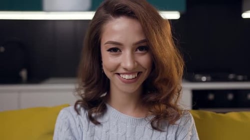Smiling Young Woman Posing in Modern Kitchen