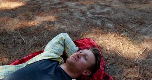 Couple lying on blanket in olive farm