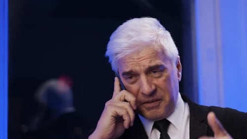 Businessman Talking on Phone at Night