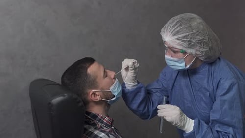 Medical Professional Administering Nasal Swab Test to Patient