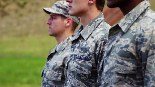 Three Soldiers Stand at Attention Outside