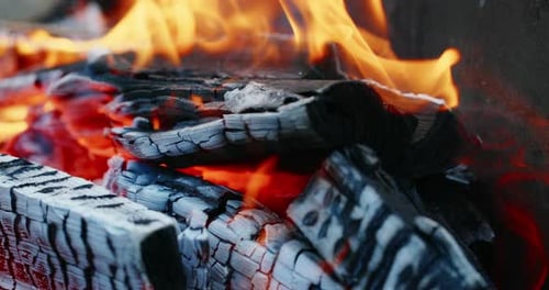 Burning Log of Wood Close-up As Abstract Background. The Hot Embers of Burning Wood Log Fire.