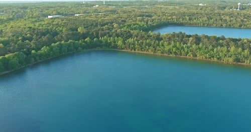 Aerial Panorama View on the Green Forest Between Turquoise Color Lake