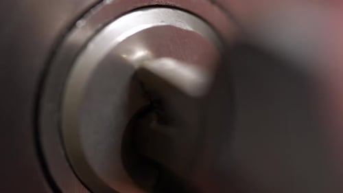 Macro Detail of Key Put Into a Keyhole and Turned Left