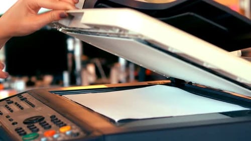 Executives using photocopy machine in office