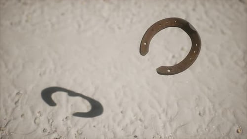 Floating Rusty Horseshoe Spinning on Sandy Ground