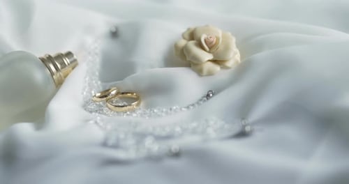 Wedding Rings and Accessories on White Satin