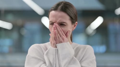 Woman Coughing and Rubbing Chest in Close Up