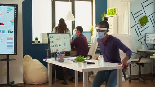 Workers in Masks at Computers in Bright Office