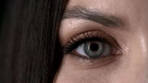 Woman's Eye Opens in Close Up