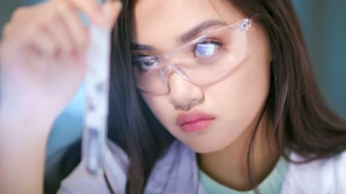 Female Scientist Examining Test Tube in Lab