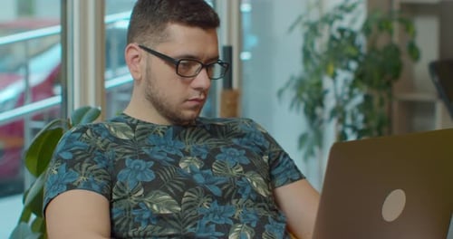 Young Adult Using Laptop Inside