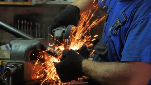 Craftsman Working With a Circular Saw, Sparks Fly From the Hot Metal