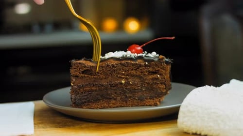 Eating Slice of Rich Chocolate Layer Cake