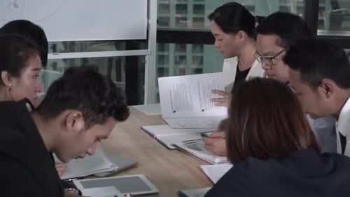 Asian Business People Discuss Marketing Strategy