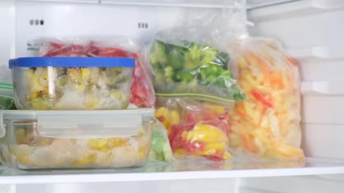 Freezer Filled with Containers of Frozen Vegetables