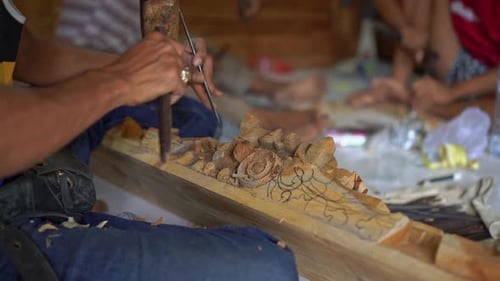 Craftsman Carving Intricate Wood Design with Chisel