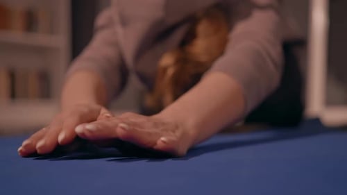 Woman Stretching Arms on Yoga Mat Indoors
