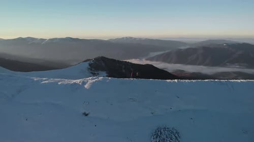 Young Couple of Hikers, Walking on Mountain Ridge in Winter
