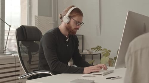 Programmer Working on PC in Office