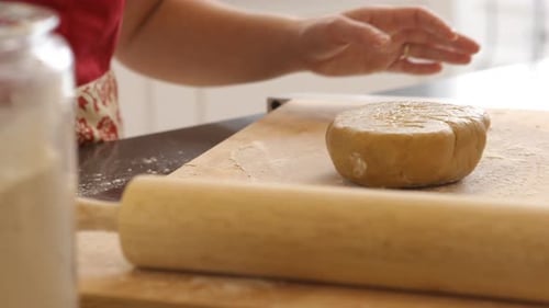 Using rolling pin to roll cookie dough