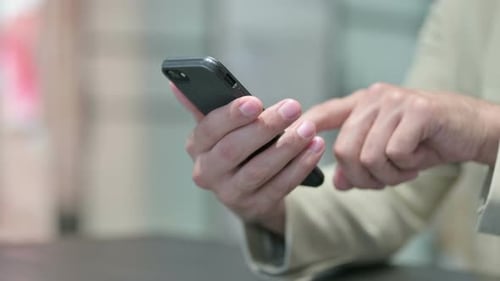 Close Up of Young Man Using Smartphone