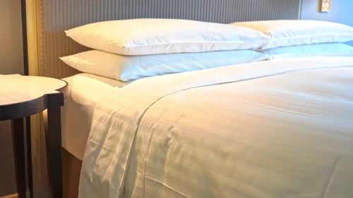 Made Bed with White Sheets and Pillows