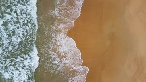 Aerial view of white sand beach and ocean wave