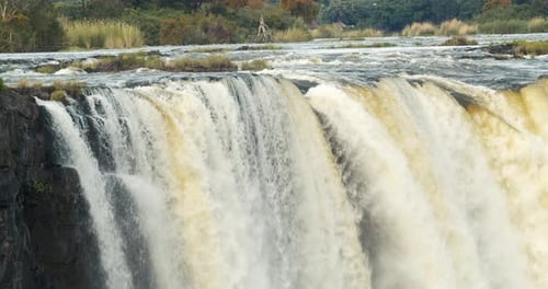 Beautiful Victoria Falls with lots water dropping down, river Zambezi, 4k