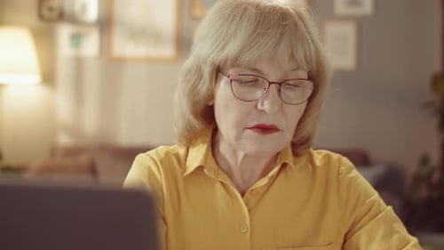 Senior Woman Working From Home on Laptop
