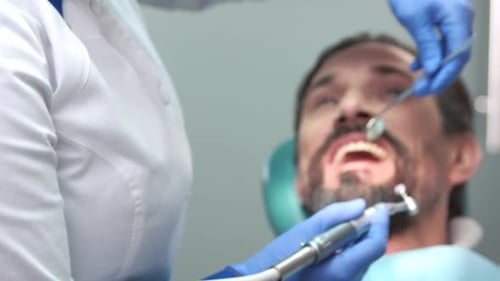 Dentist Is Cleaning Teeth.