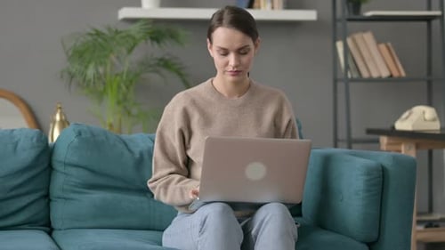 Woman Working on Laptop at Home