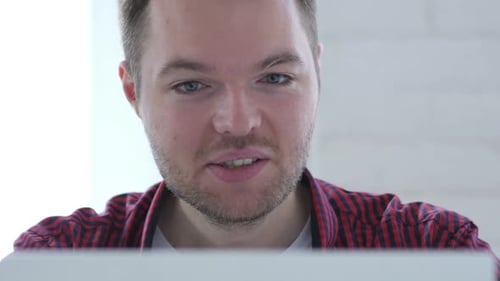 Online Video Chat By Young Man at Work Close Up